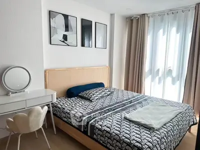 Modern bedroom with stylish decor and natural light, featuring a cozy bed and elegant furniture.