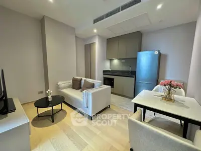 Modern open-plan living room with sleek kitchen and cozy seating area
