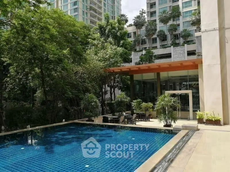 Luxurious condominium with serene swimming pool and lush greenery