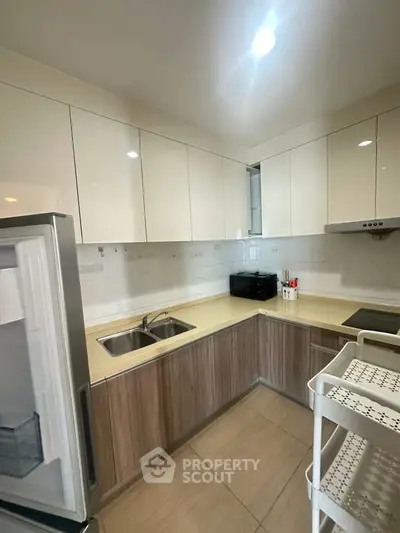 Modern kitchen with sleek cabinetry and built-in appliances in a compact layout.