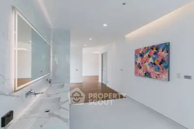 Luxurious modern bathroom with elegant marble finishes and vibrant artwork