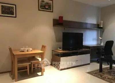 Modern living room with dining area and TV setup, ideal for cozy urban living.