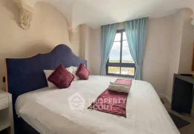 Elegant bedroom with large window and stylish decor in a luxurious property.