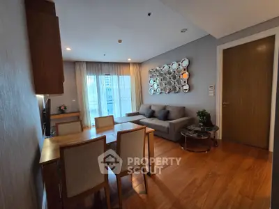 Modern living room with stylish decor and wooden flooring in a cozy apartment setting.