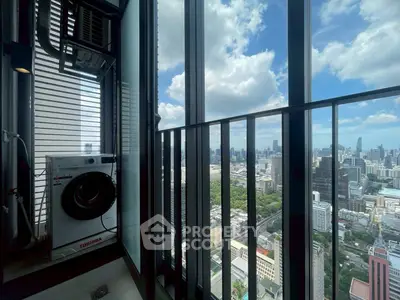 Stunning high-rise balcony view with cityscape and in-unit washing machine.