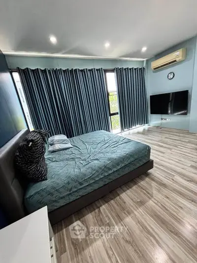 Spacious modern bedroom with large windows and stylish decor