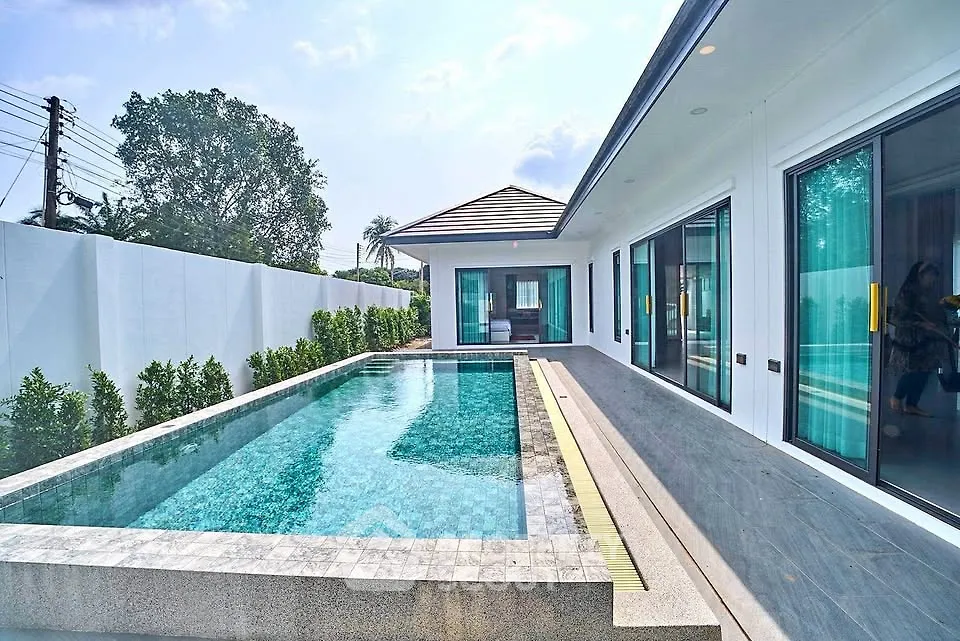 Luxurious modern home with private pool and sleek exterior design, perfect for relaxation and entertainment.