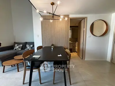 Modern living room with stylish dining area and contemporary lighting