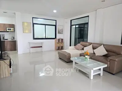 Spacious modern living room with sleek furniture and natural light