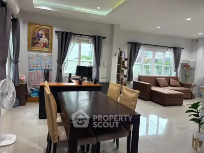 Spacious living room with modern furniture and ample natural light, perfect for family gatherings.
