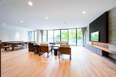 Spacious modern living room with large windows and elegant wooden flooring