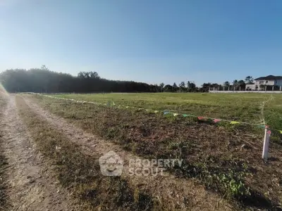 Expansive plot of land with clear blue sky, ideal for development or investment opportunities.