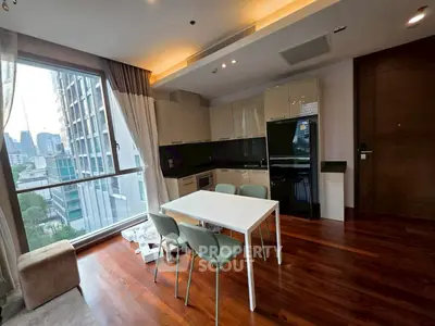Modern kitchen with dining area and city view in high-rise apartment
