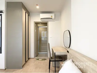 Modern minimalist studio apartment with sleek furniture and ample natural light, perfect for urban living.