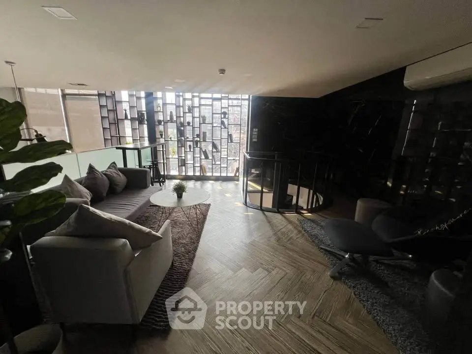 Luxurious modern living room with stylish decor and spiral staircase, perfect for urban living.