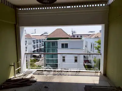 Spacious balcony with a view of modern residential buildings, perfect for relaxation and enjoying the outdoors.