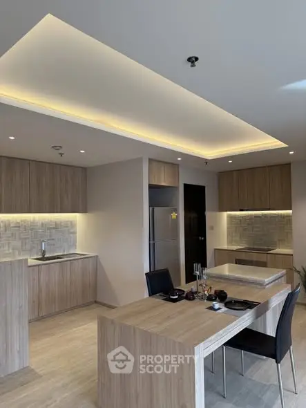 Modern kitchen with sleek wooden cabinetry and integrated lighting