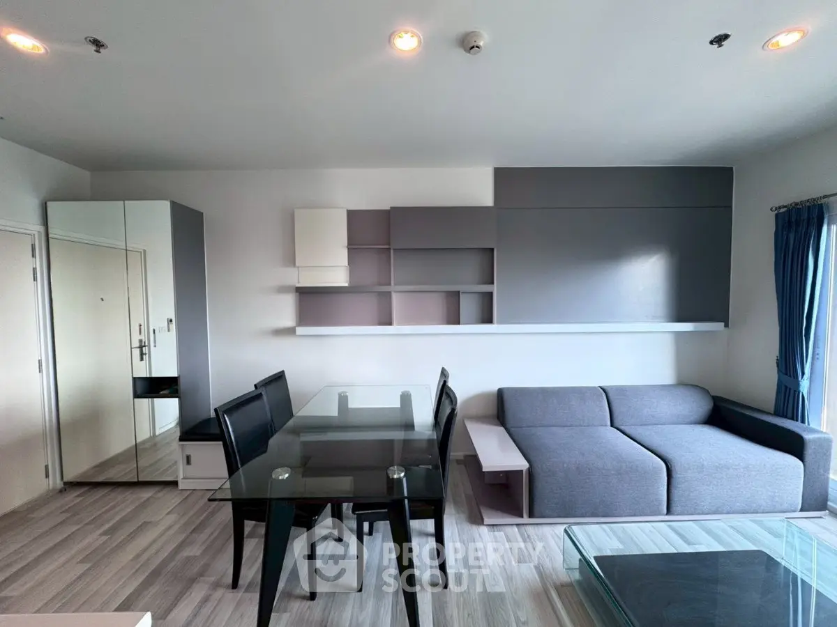 Modern living room with sleek furniture and stylish shelving in a contemporary apartment.