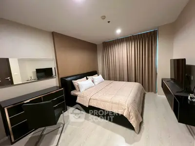 Modern bedroom with sleek furniture and cozy ambiance in a stylish apartment.