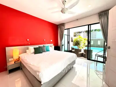 Spacious bedroom with pool view and vibrant red accent wall