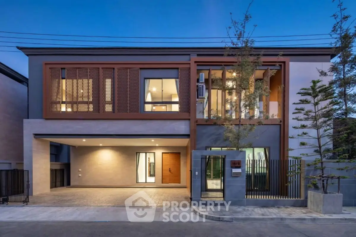 Modern two-story house with spacious driveway and contemporary design.