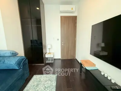 Modern living room with sleek furniture and wall-mounted TV