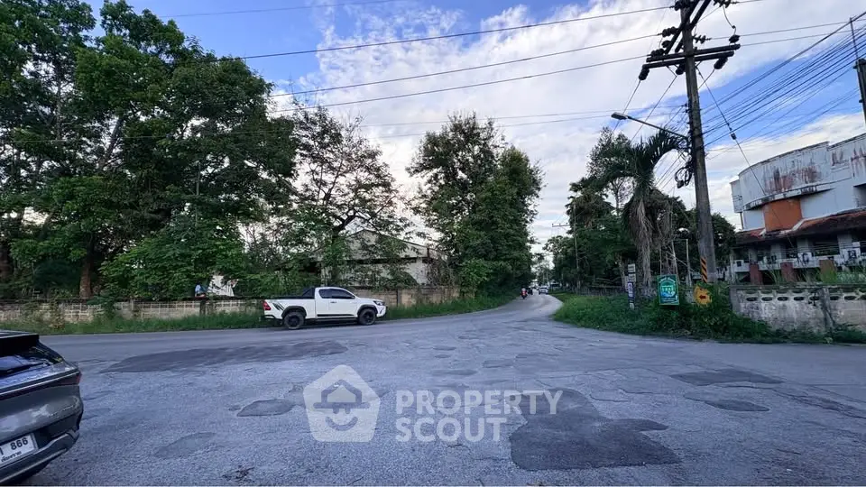 Scenic suburban street view with lush greenery and clear blue sky
