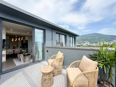 Stylish balcony with mountain view and cozy seating in modern apartment