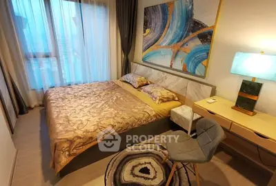 Luxurious bedroom with modern decor and large window offering natural light.