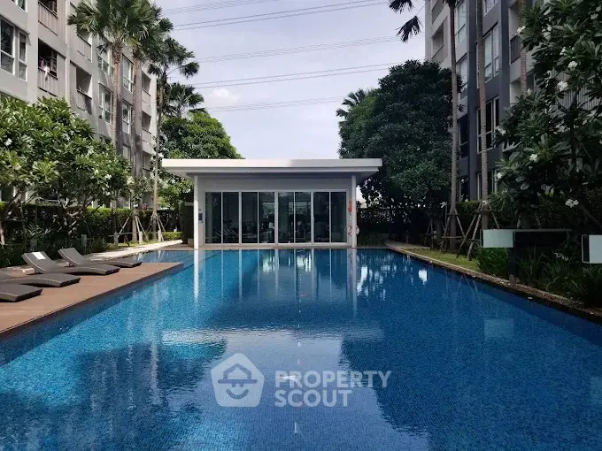 Luxurious residential pool area with modern design and lush greenery.