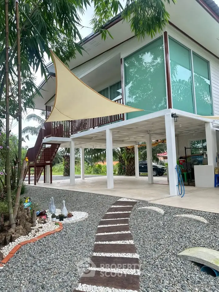 Modern two-story house with stylish exterior and landscaped garden pathway.