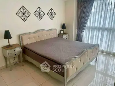 Elegant bedroom with stylish decor and large window for natural light.