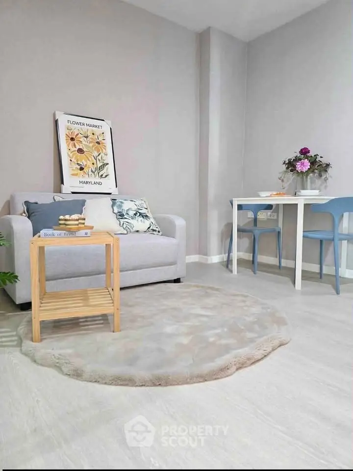 Charming living room with cozy sofa, stylish decor, and elegant dining area in modern apartment.