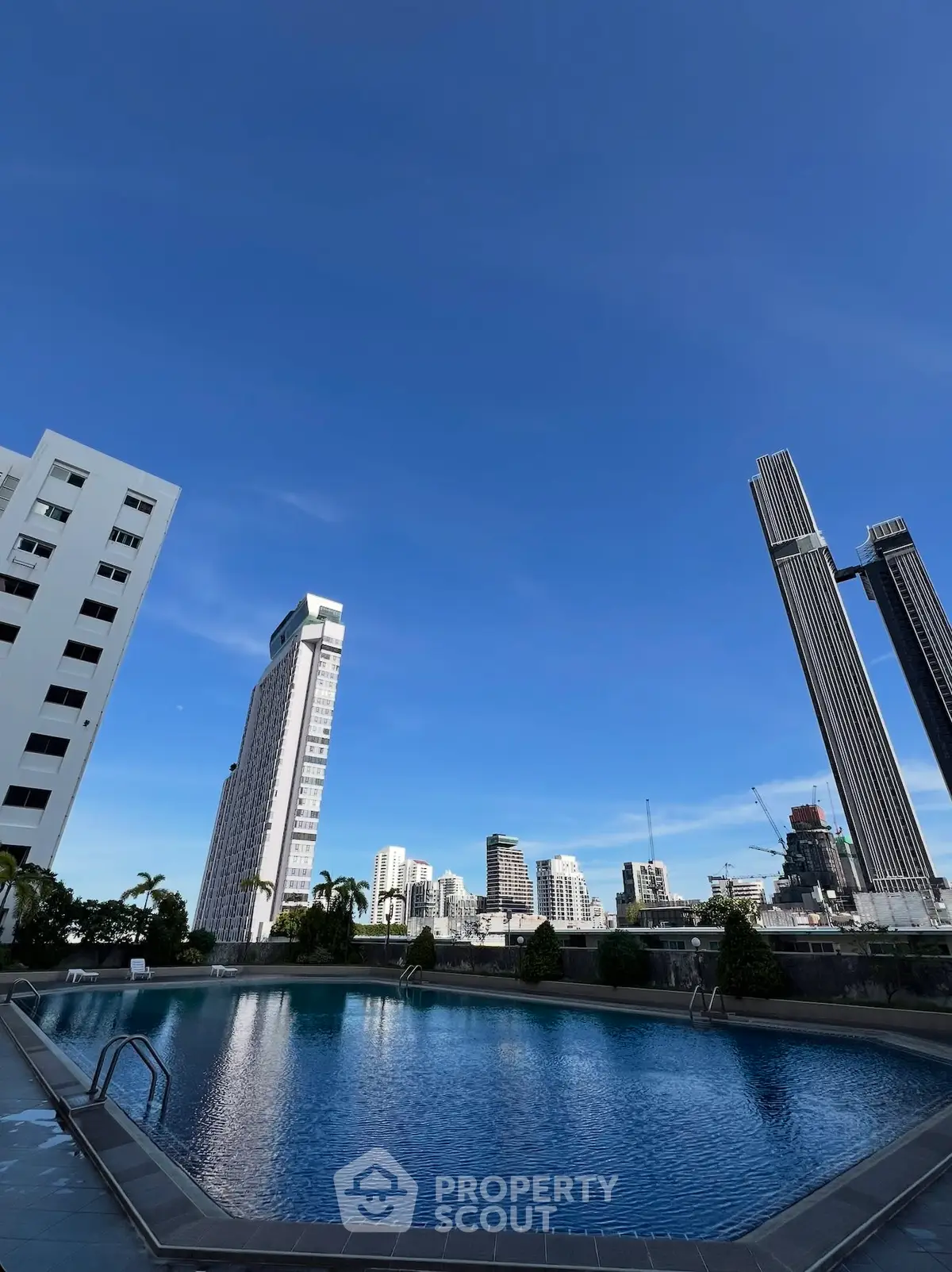 Stunning rooftop pool with panoramic city skyline views, perfect for luxury urban living.