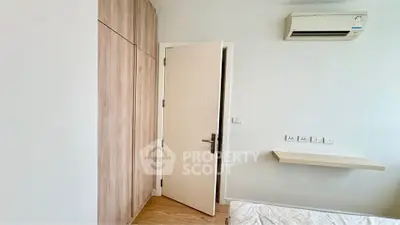 Modern minimalist bedroom with wooden wardrobe and air conditioning