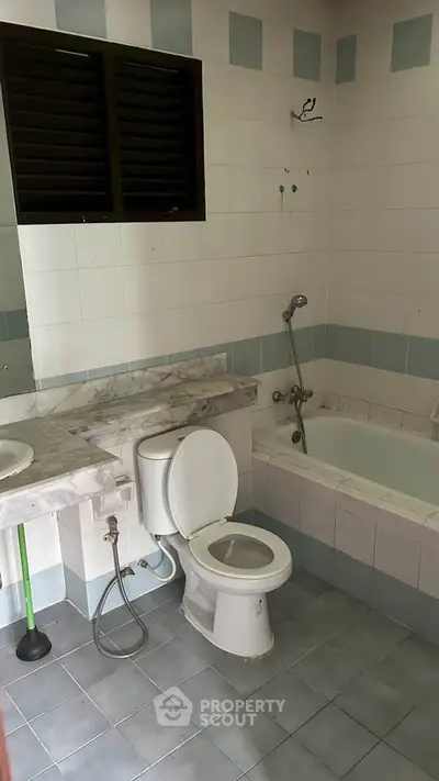 Spacious bathroom with bathtub and modern fixtures in a stylish real estate property.