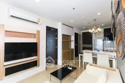 Modern living room with open kitchen, stylish decor, and elegant lighting in a contemporary apartment.