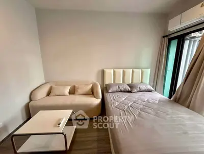 Modern bedroom with cozy sofa and stylish bed in a well-lit apartment