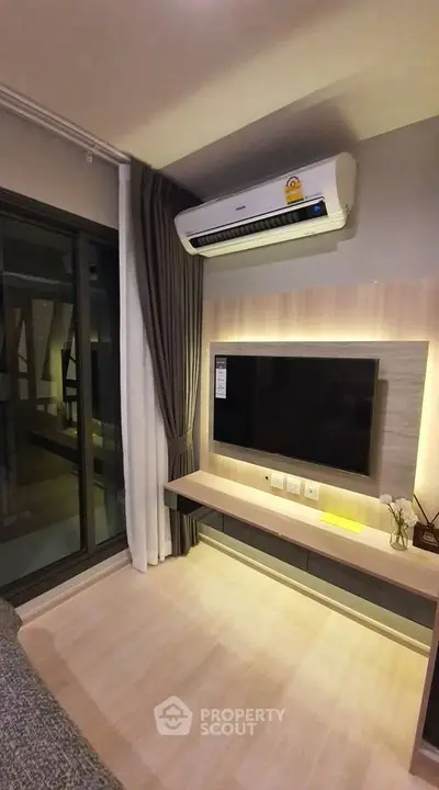 Modern living room with wall-mounted TV and air conditioning unit