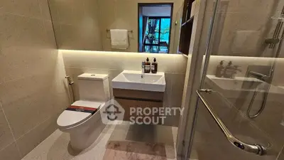 Modern bathroom with sleek fixtures and glass shower enclosure