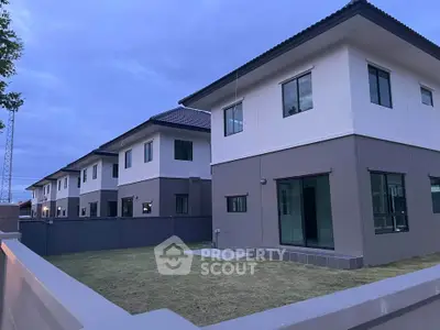 Modern two-story homes with spacious yards in a serene neighborhood setting.