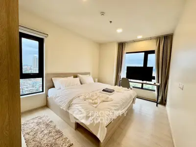 Spacious bedroom with city view and modern furnishings