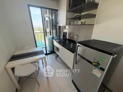 Modern compact kitchen with balcony view and sleek appliances