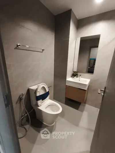 Modern bathroom with sleek design and contemporary fixtures in a stylish real estate property.