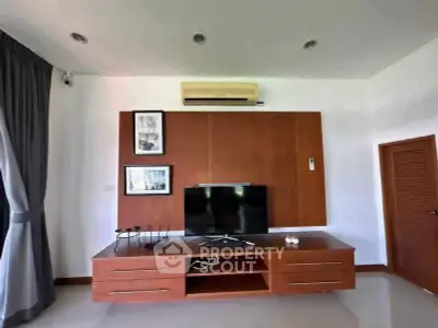 Modern living room with sleek TV unit and air conditioning