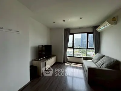 Modern living room with city view, featuring sleek furniture and large window for natural light.