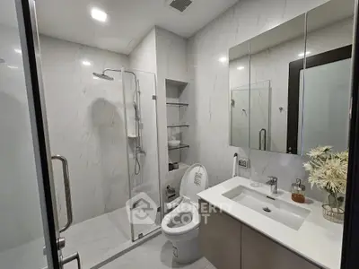 Modern bathroom with sleek design, glass shower, and elegant fixtures in a contemporary home.