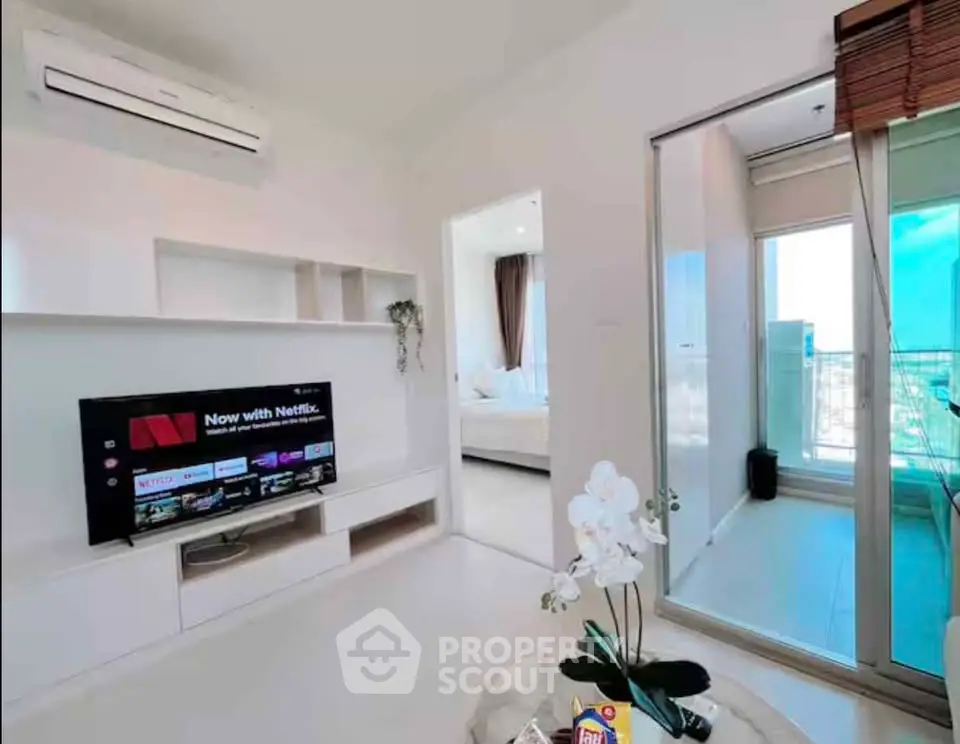 Modern living room with TV and balcony access in a stylish apartment