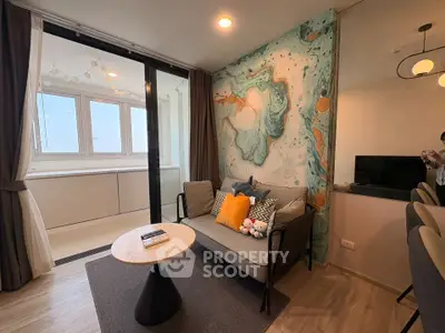 Stylish living room with modern decor and large windows in a cozy apartment.