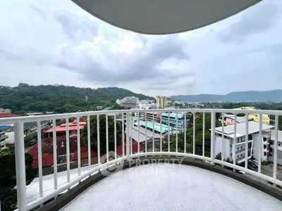 Stunning balcony view overlooking cityscape and lush greenery, perfect for relaxation.